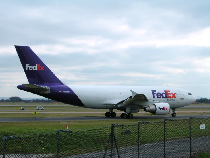 an fedex jetliner on a runway at an airport