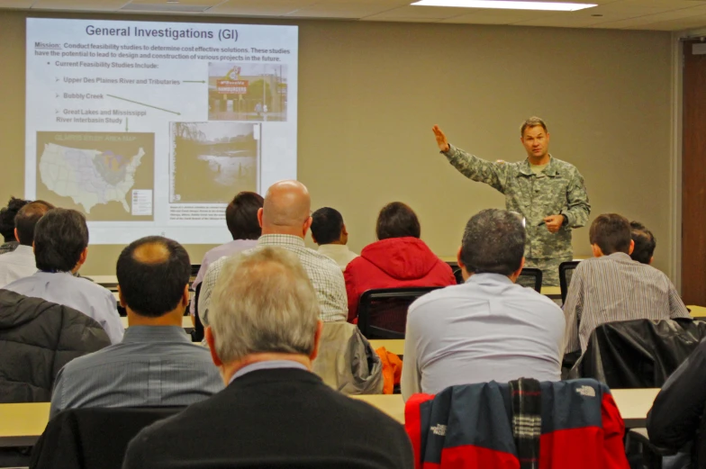 a soldier speaks to an audience of people