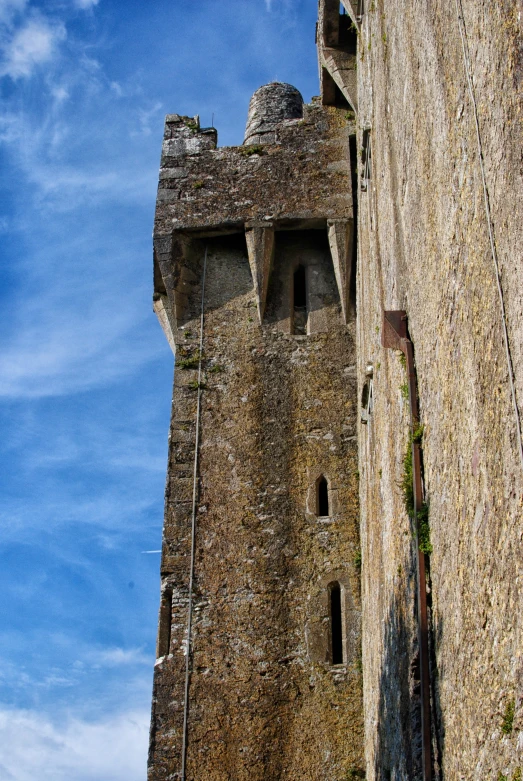 a very tall brick structure on the side of a hill