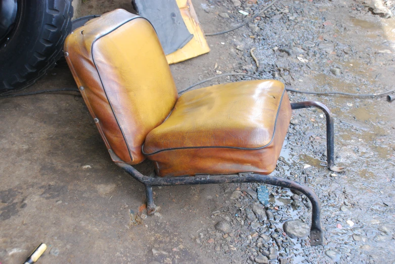 this is a small yellow chair with rusty edges