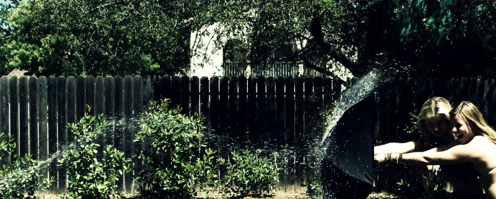 an image of a woman outside taking a shower