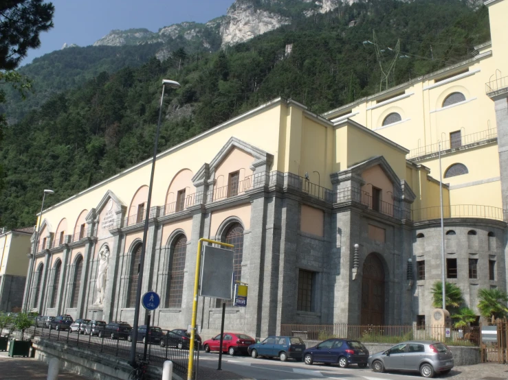 a large beige building sitting on the side of a hill