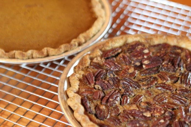 there is a pie in the bottom and a pie top with pecans on the bottom