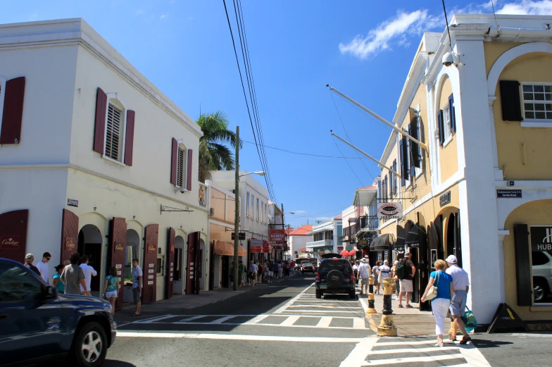 people walk down an old - fashioned city street