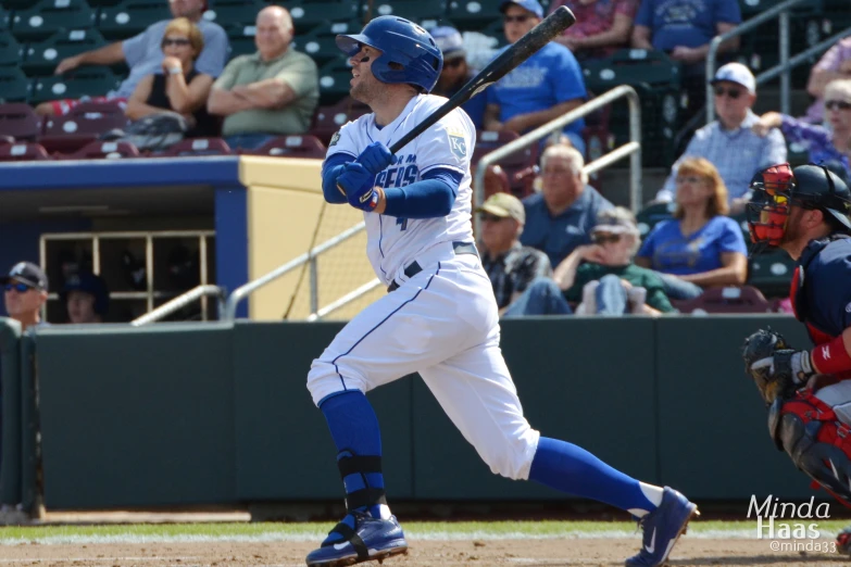 a baseball player holding a bat near home plate