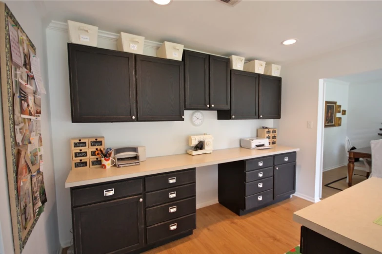 a kitchen with black cabinets and lots of drawers