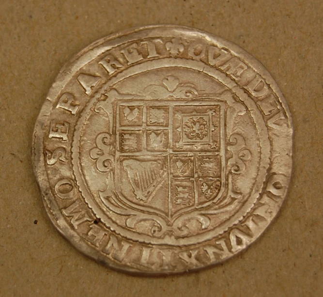 a close up view of a coin on a brown surface