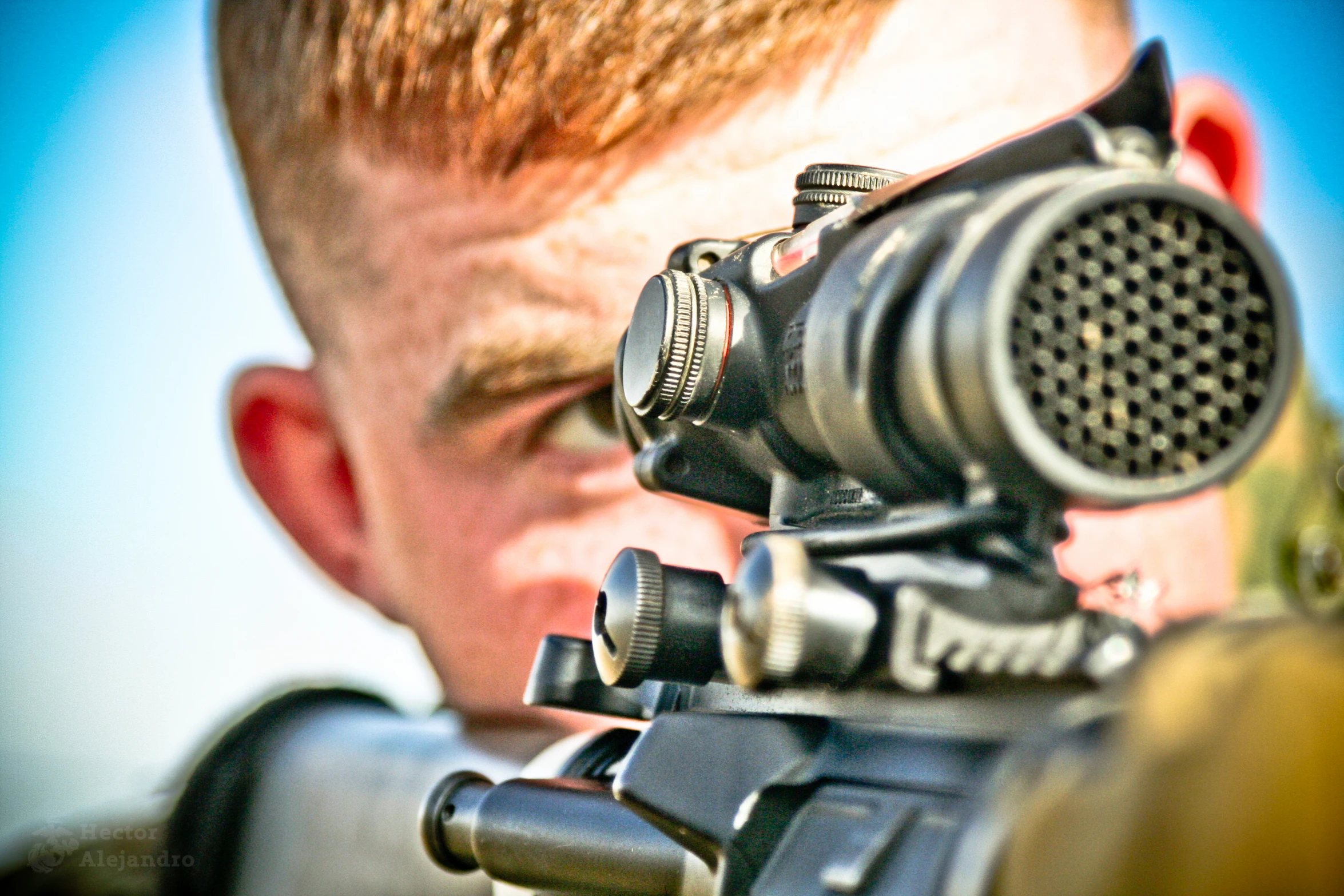 a man looks through a scope on a rifle