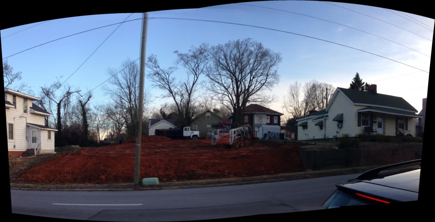 an older neighborhood with red dirt that has been pulled over