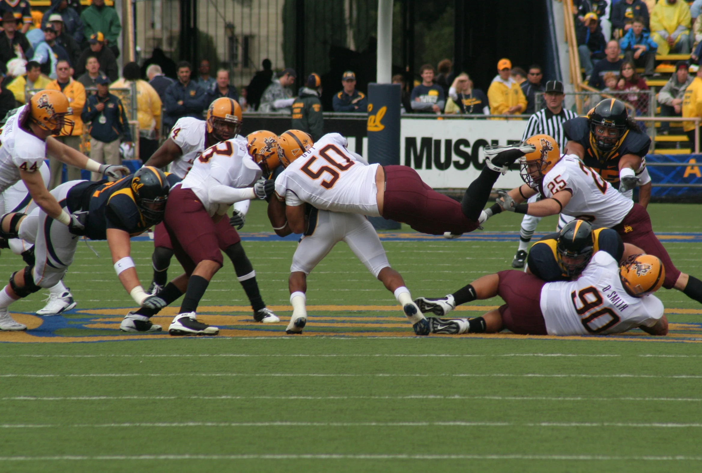 several players trying to escape from the tackler during a football game