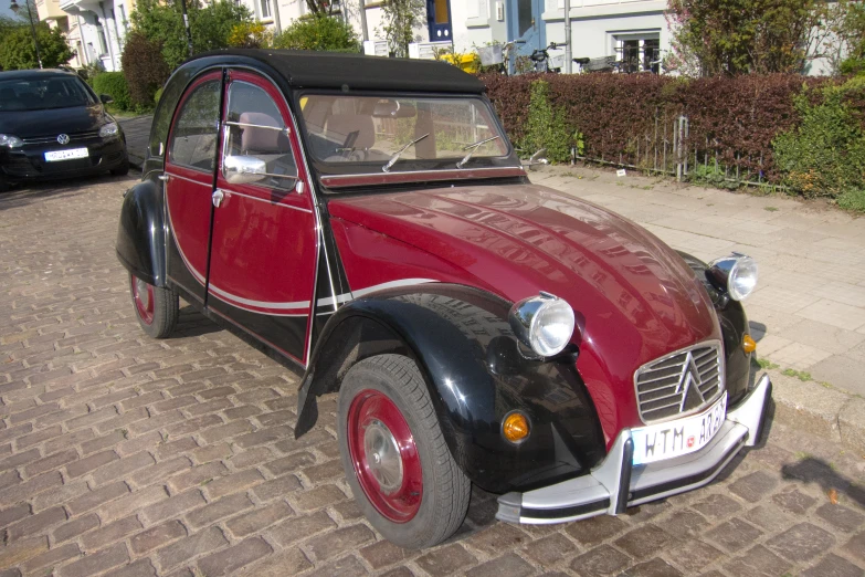 an old fashion car parked near a street curb