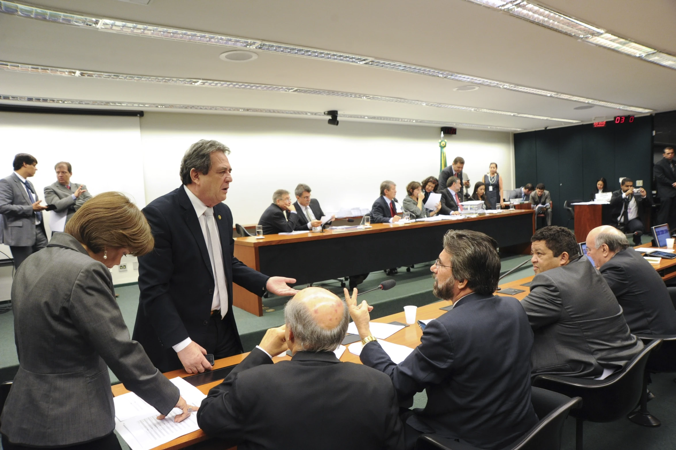 a man is speaking to his boardroom in the middle of the room