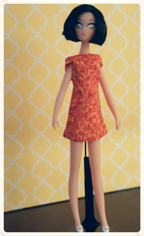 a doll with a red and orange dress