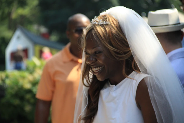 a bride smiles at the pographer as she walks down the aisle