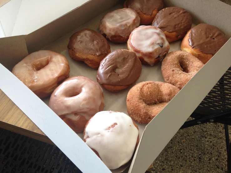 box of a dozen doughnuts with frosting