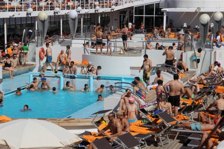 a bunch of people at a pool in a large boat