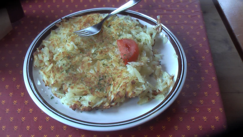 a plate with food on it next to a fork