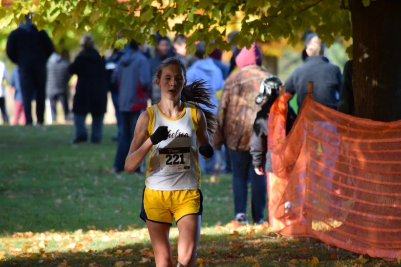 a female runner is in the orange course