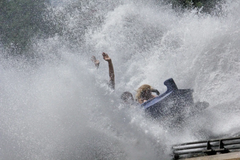 the wakeboarder catches air as he rides on his board