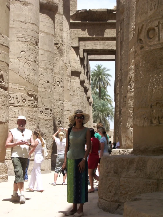 an image of a woman standing near columns