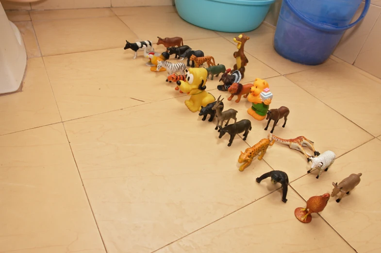 small toy animals are lined up in the same row