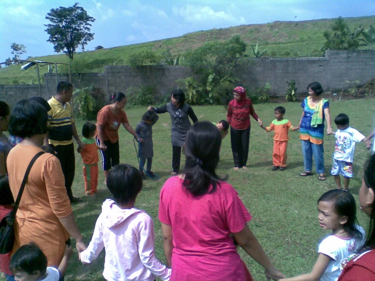 a family is playing with a frisbee in the back yard