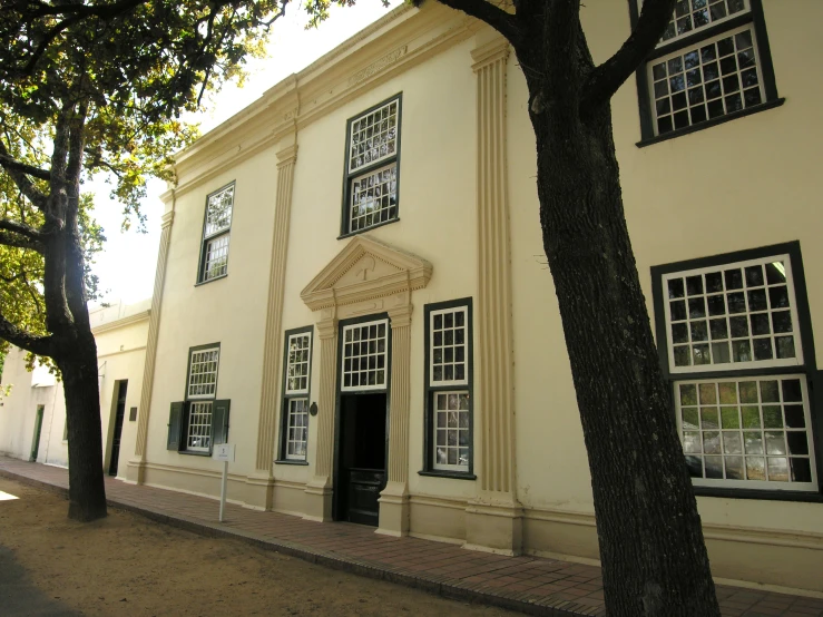 a yellow and white building with windows on both sides