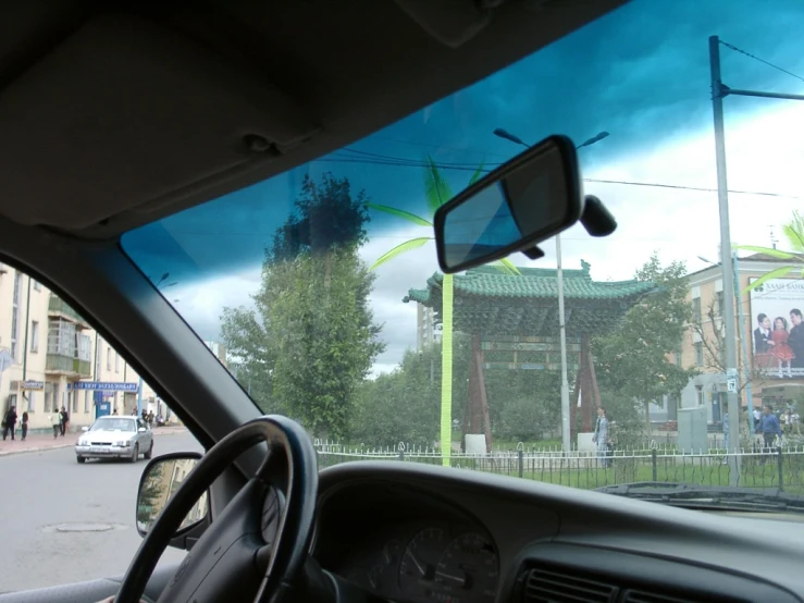 a view of a building and street from inside of a vehicle