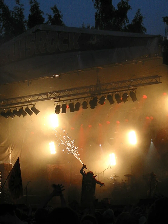 two people on stage with fireworks in front of them