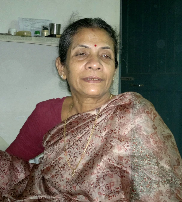 a woman sitting with a scarf on her shoulders