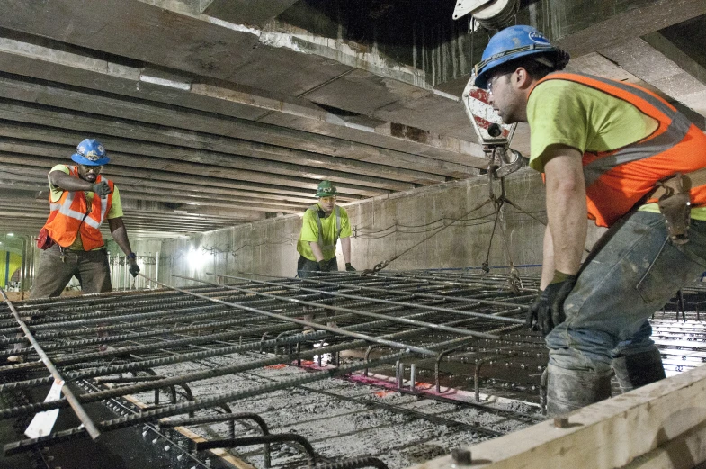 workers stand and work in the construction area