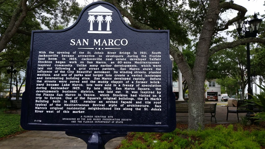 a marker about the san marco community in an urban park