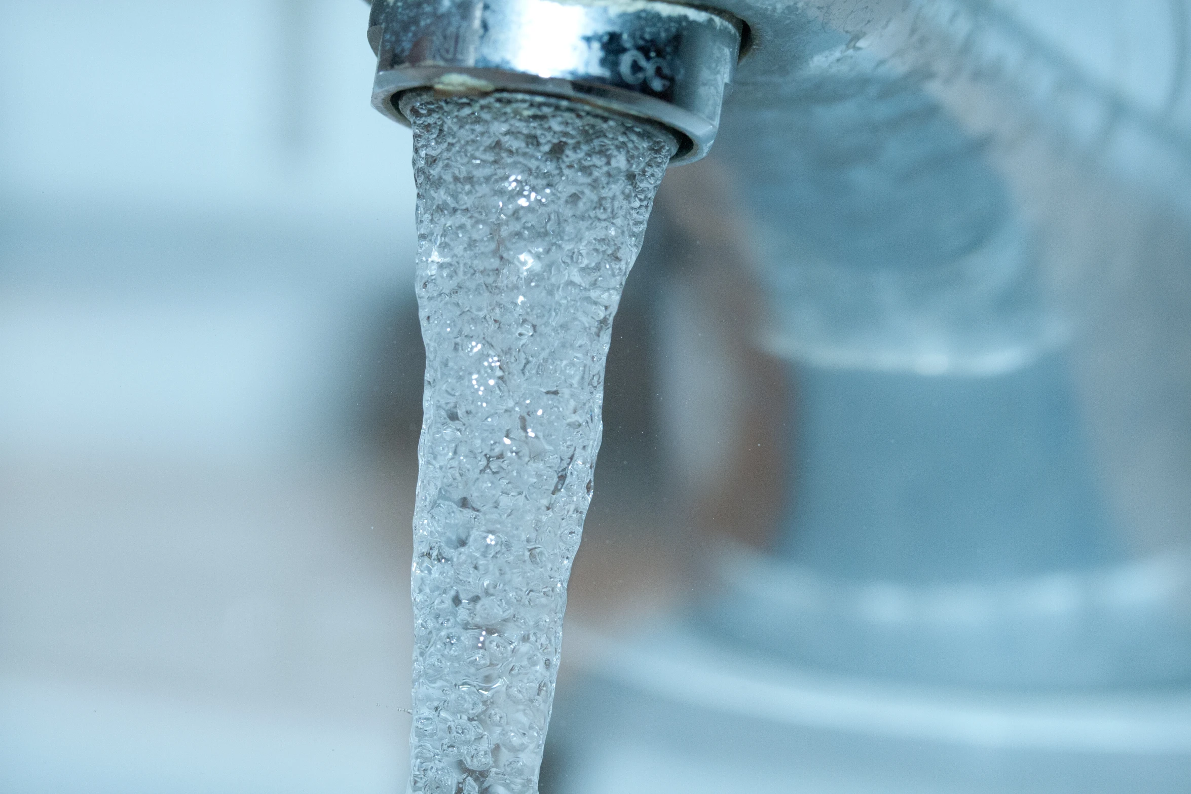 a closeup of a stream of water running from a faucet