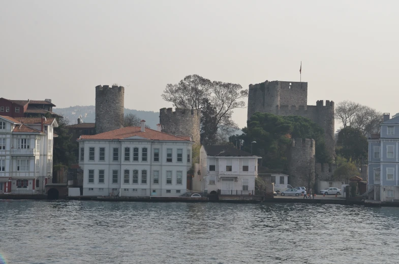 the old castle is next to a body of water