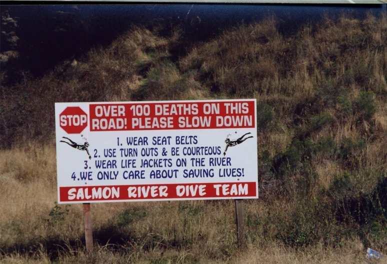 a road sign on the side of a hill