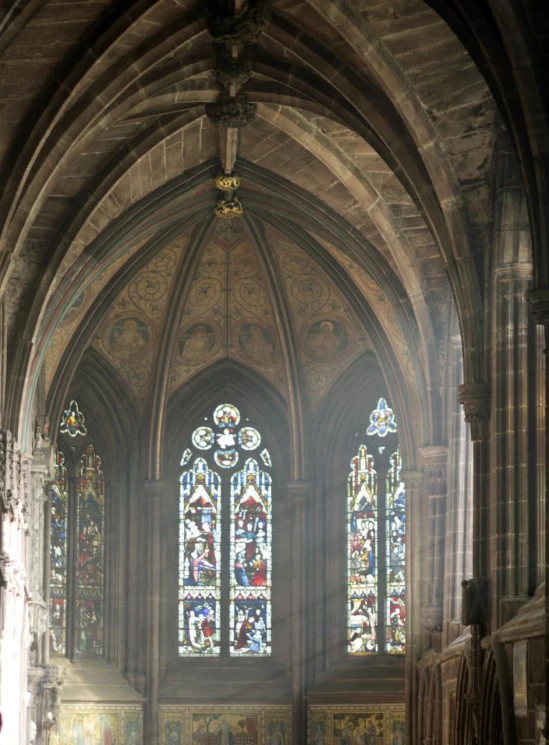 an old church has stained glass windows and a statue