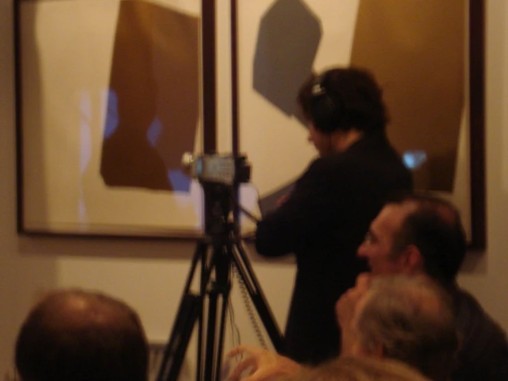 a woman is using a video camera