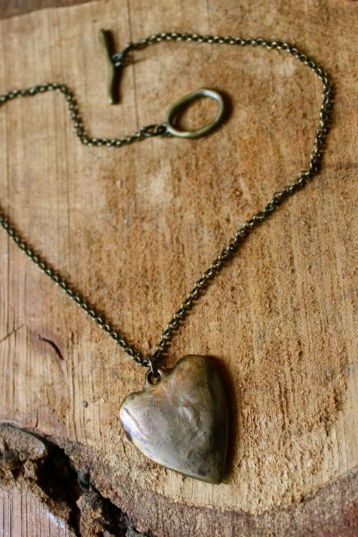 this is a heart shaped necklace on a table