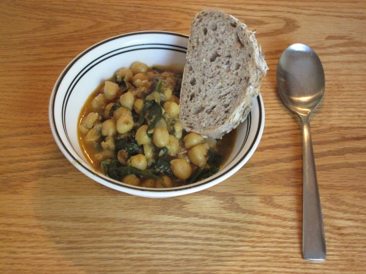 a meal in a bowl with a spoon on a table