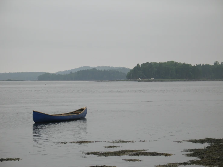 a small boat is in a body of water