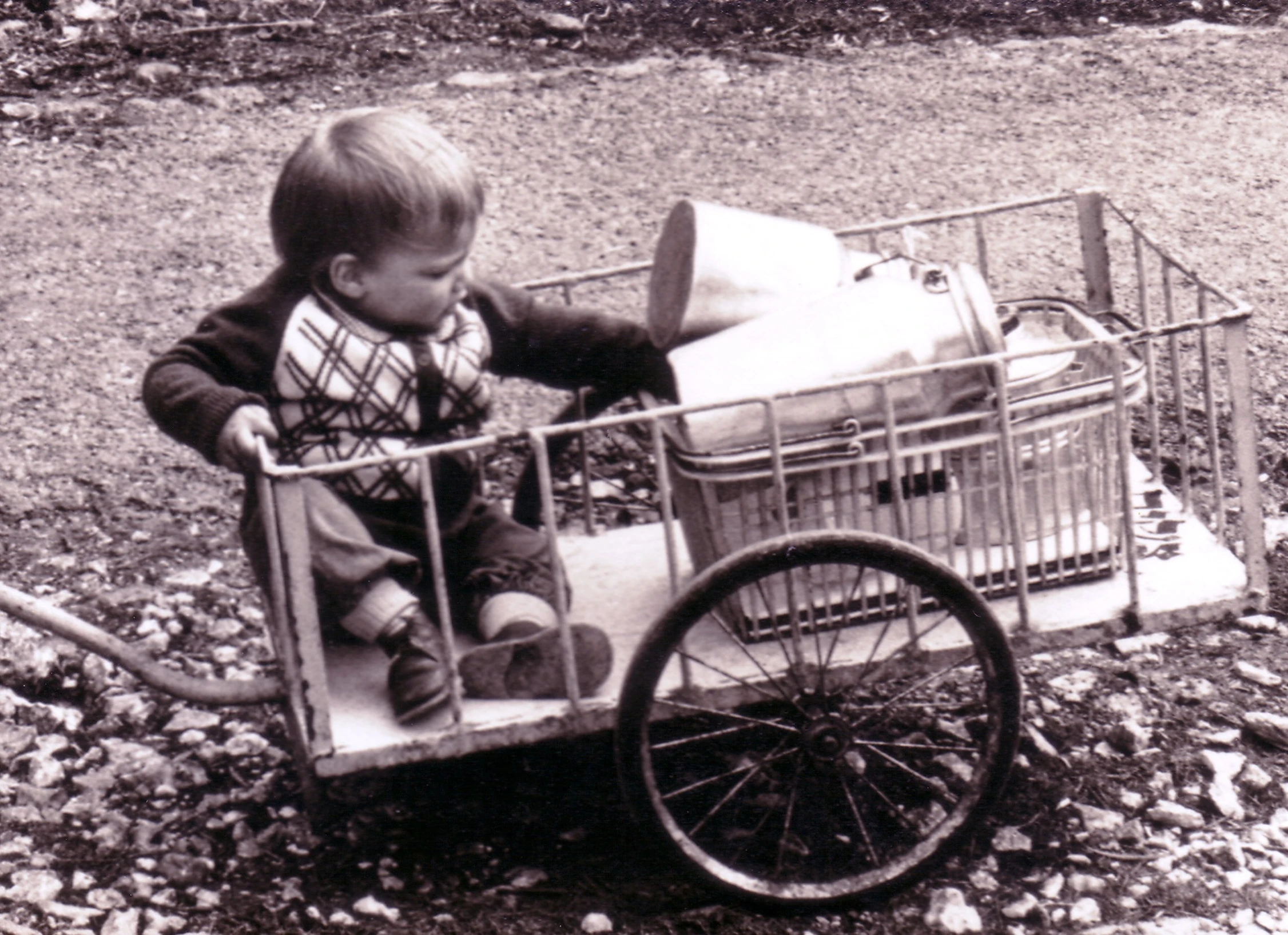 a small boy is sitting in a wagon