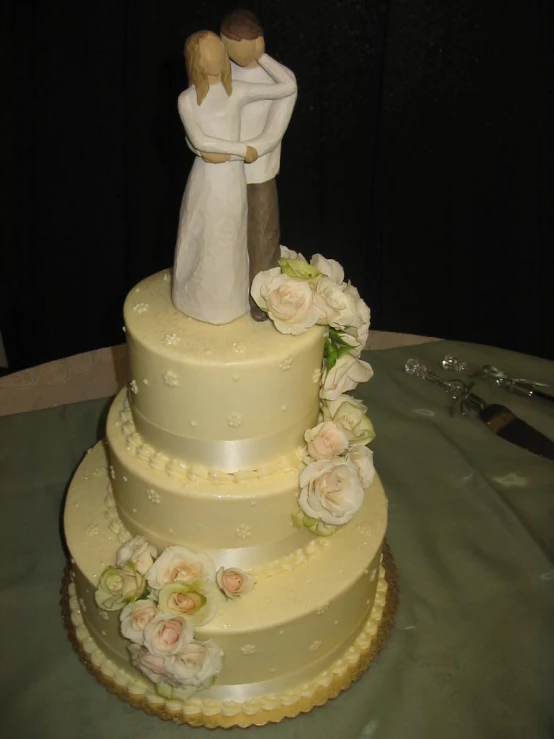 a cake with an angel and wedding couple on top