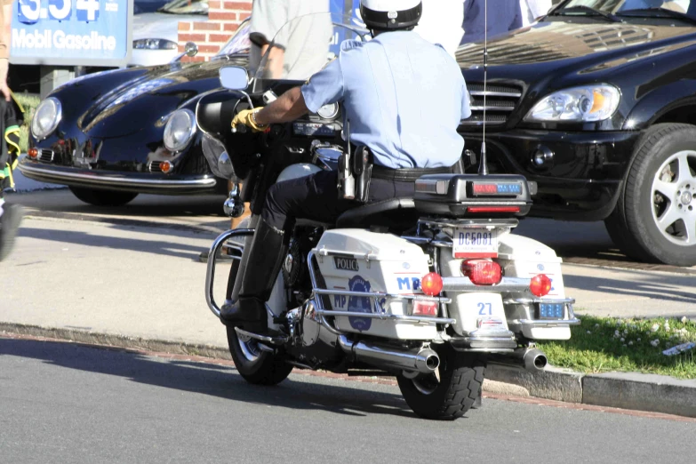 a motorcycle police officer riding down a city street