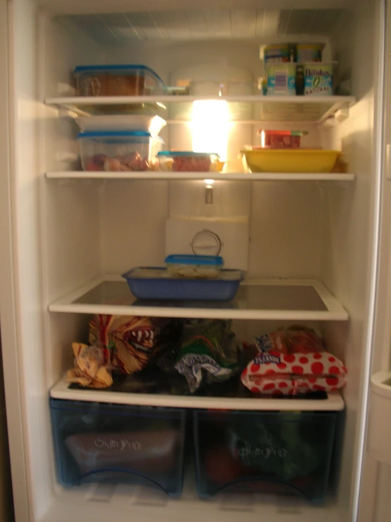 a refrigerator with some food inside of it