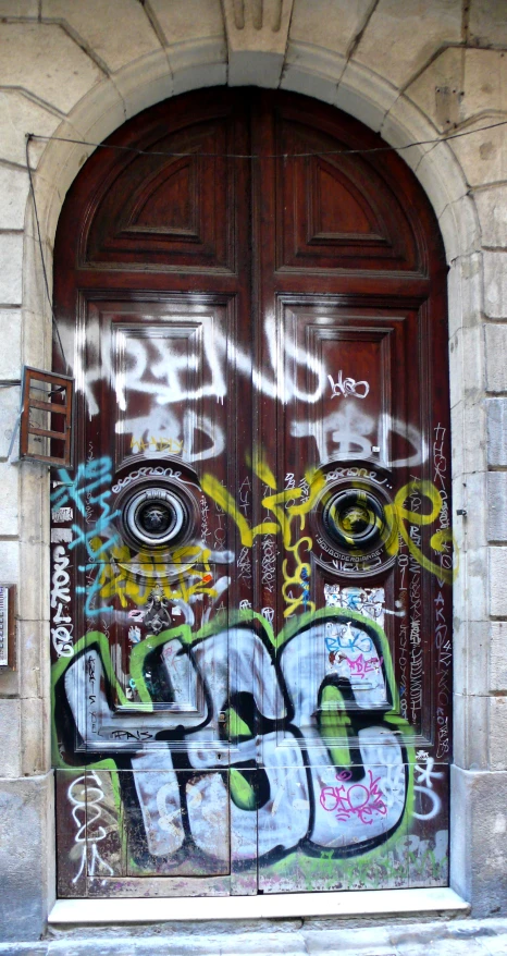 a red door with some graffiti on it