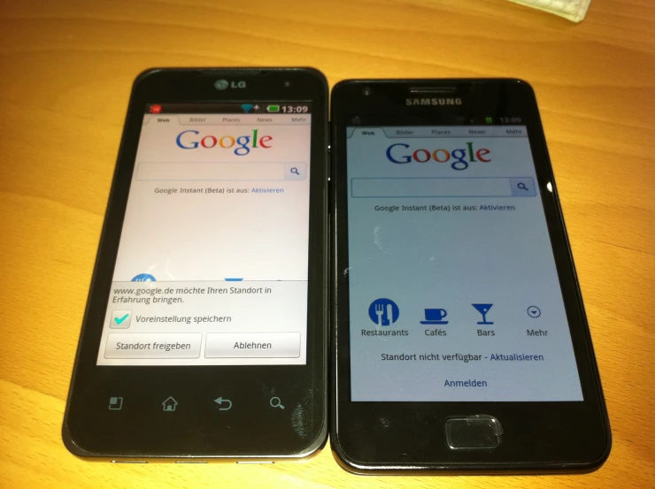 two phones that are sitting side by side on a table