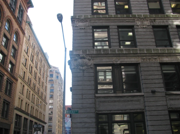 tall brick building in the city next to other buildings