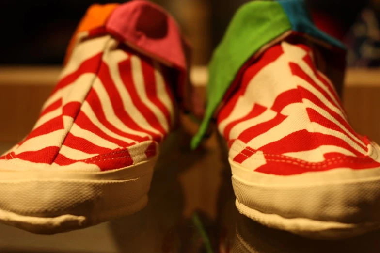 the red and white sneakers are decorated with green and yellow