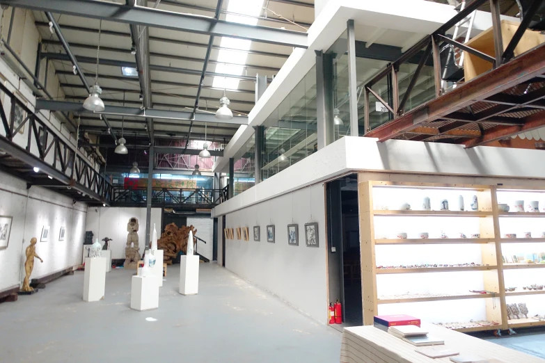 some white walls and white vases hanging in a warehouse