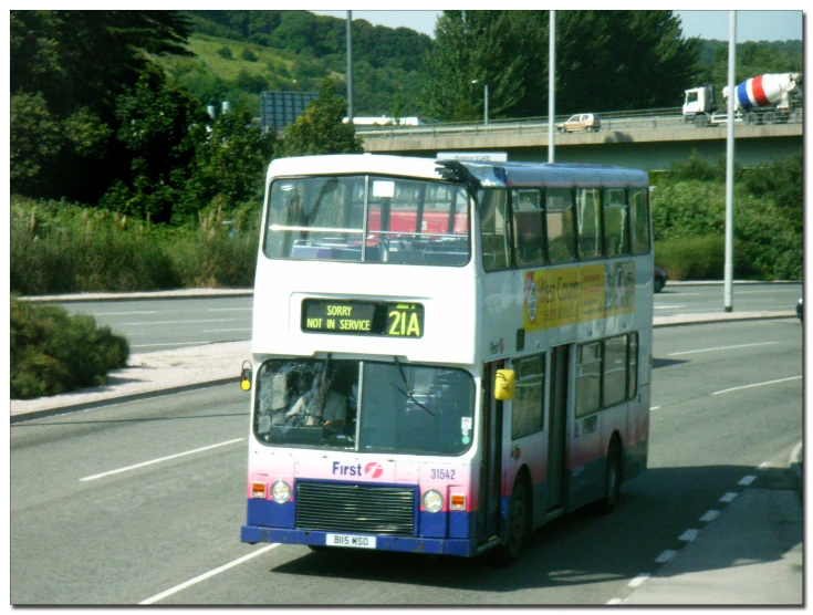 a double decker bus drives down the street